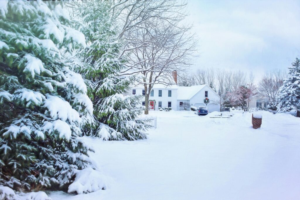 Snowfall Beautiful snowy neighborhood with frosted trees and a cozy house in winter.